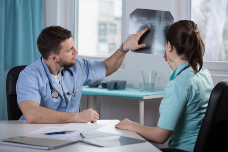 a doctor explains an x-ray with a patient